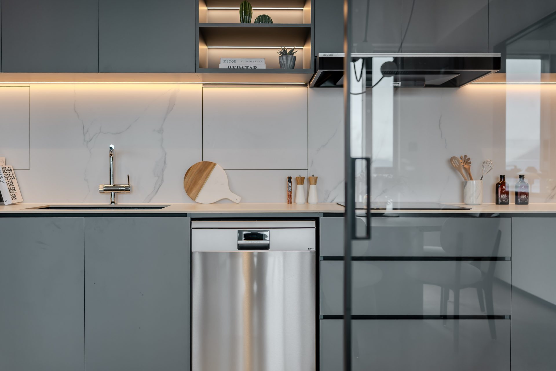 Double Cove — grey-green cabinetry, dishwasher and black-framed glazed sliding door