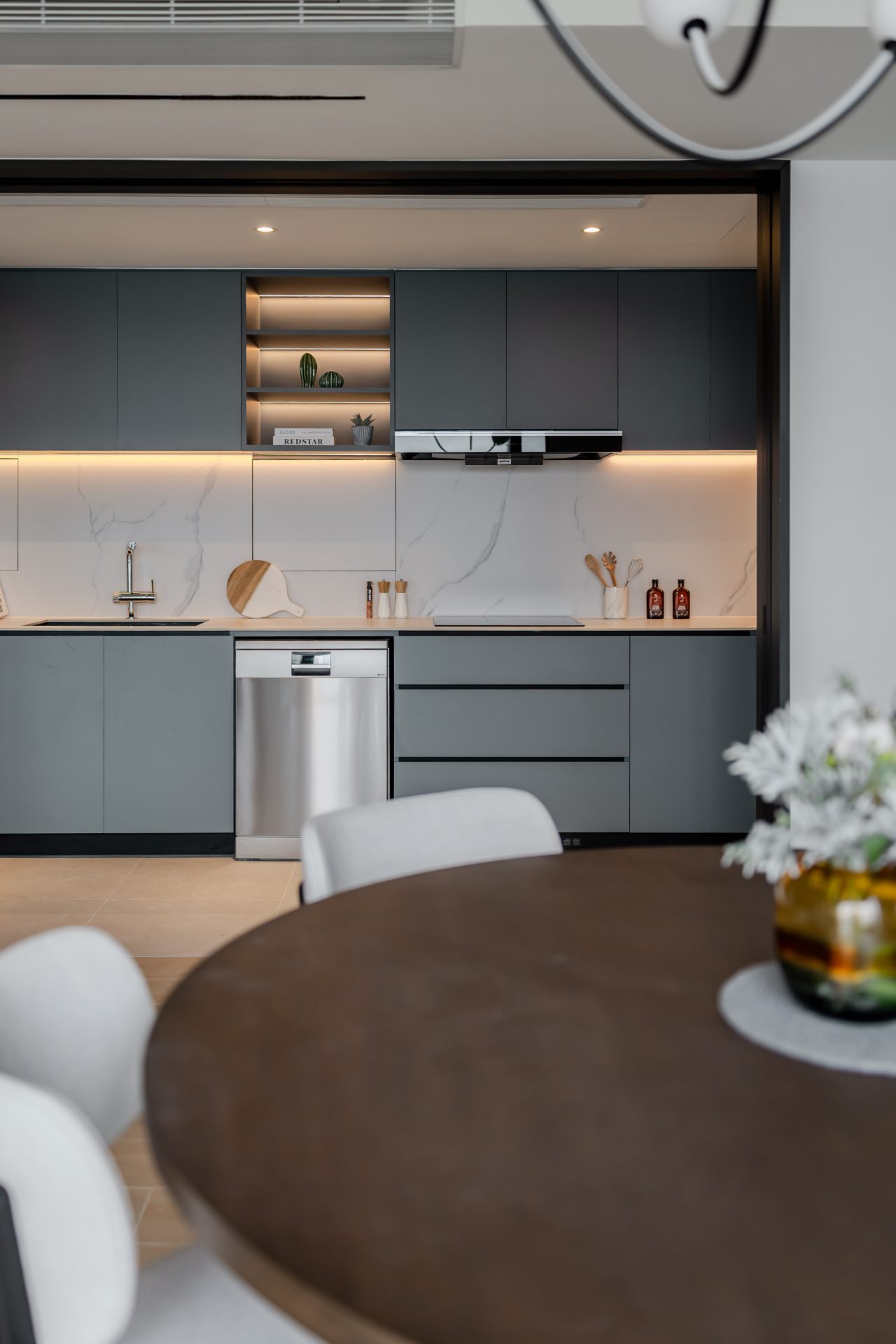 Double Cove — grey-green kitchen worktop and appliances behind the dining table