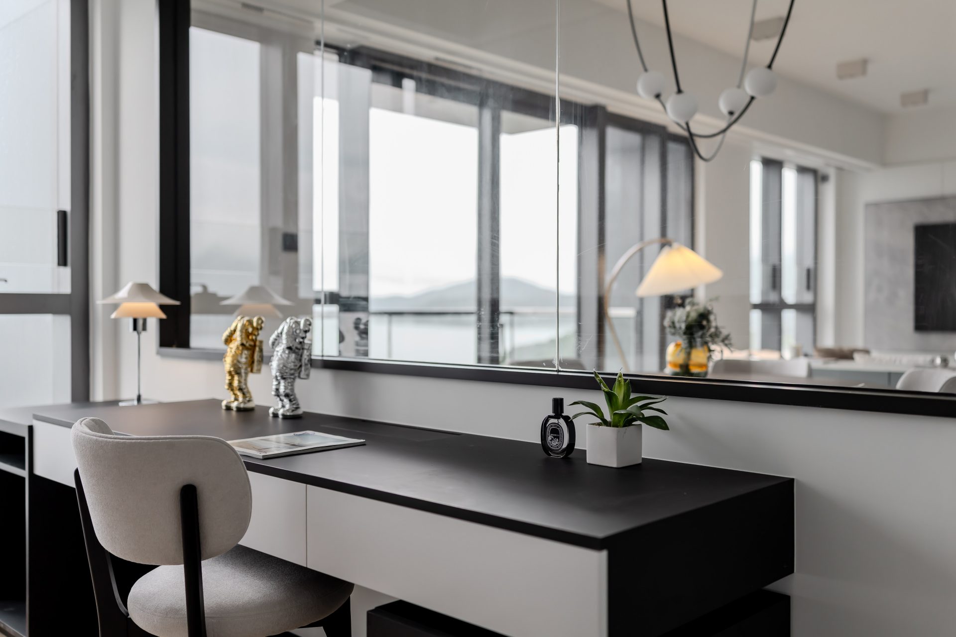 Double Cove — window-side study desk with dark storage and a city view
