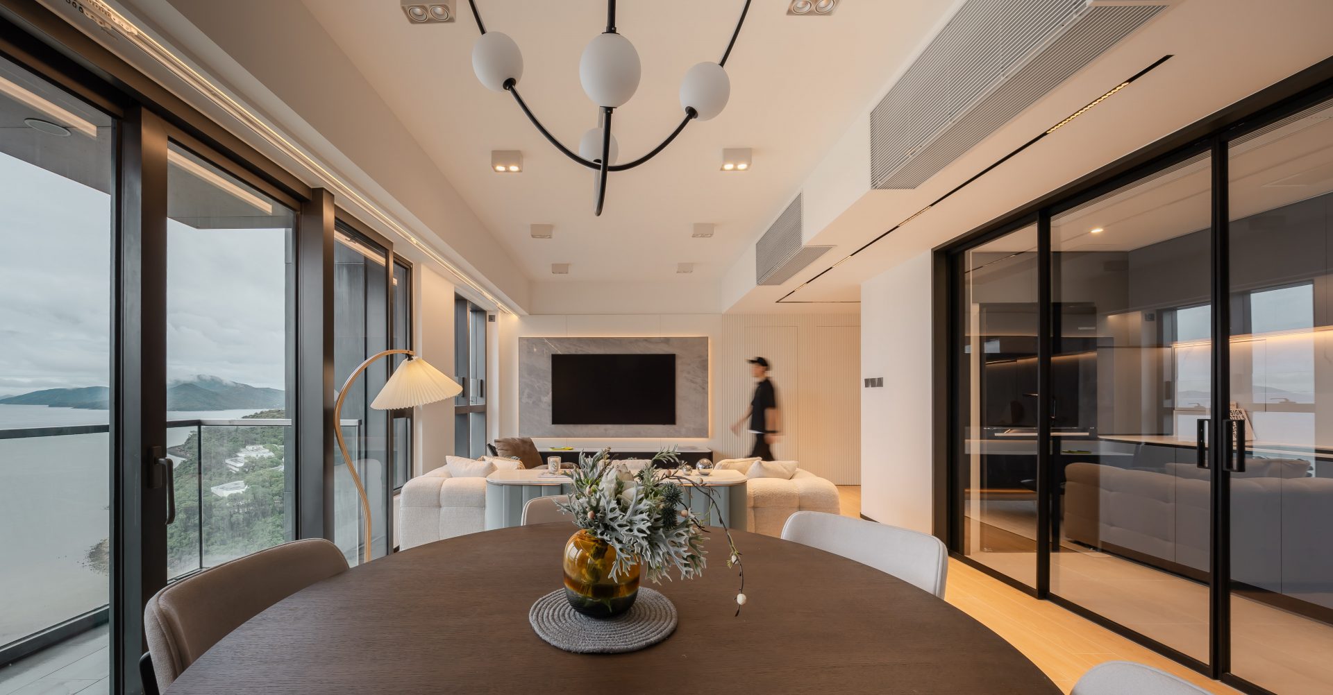 Double Cove — view from the round dining table toward the living room, glazed kitchen and TV wall