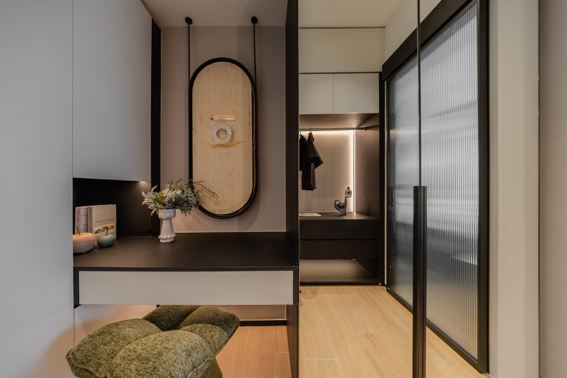 Double Cove — entrance with dark built-in storage, a mirror and black-framed glazed door