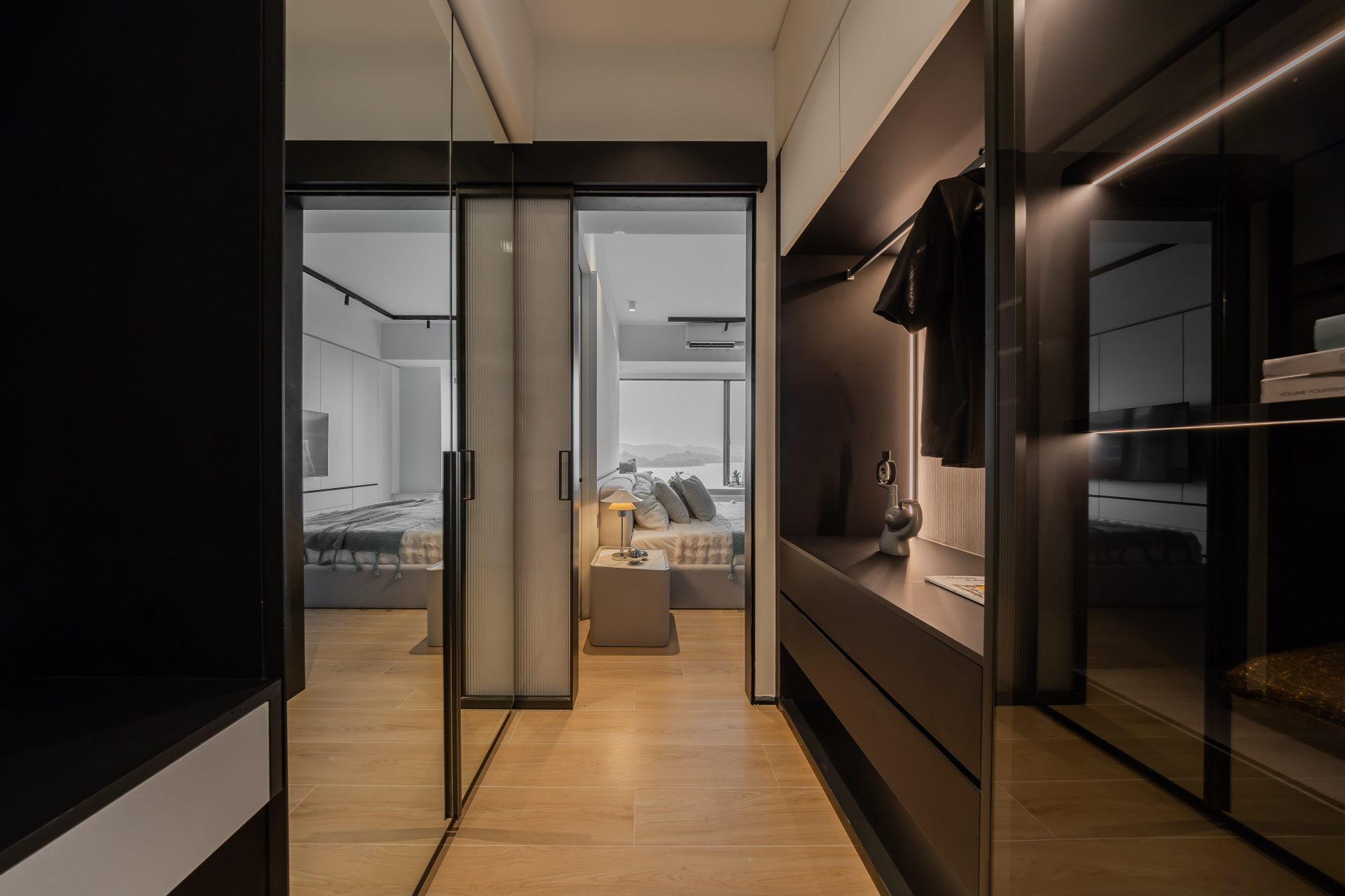 Double Cove — corridor with dark built-in storage and a glazed door leading to the bedroom
