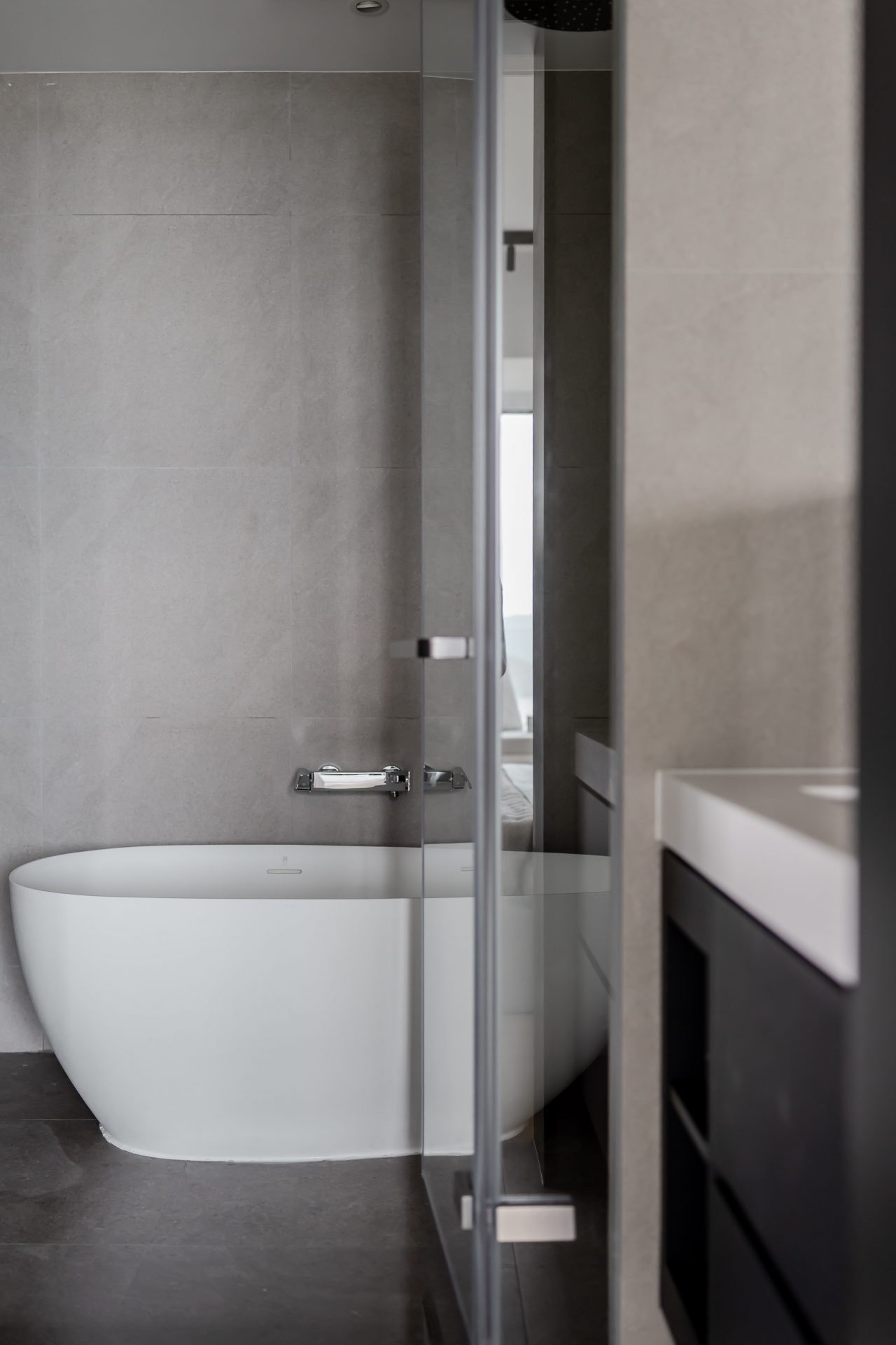 Double Cove — thermostatic shower controls and wall finish inside a glass enclosure
