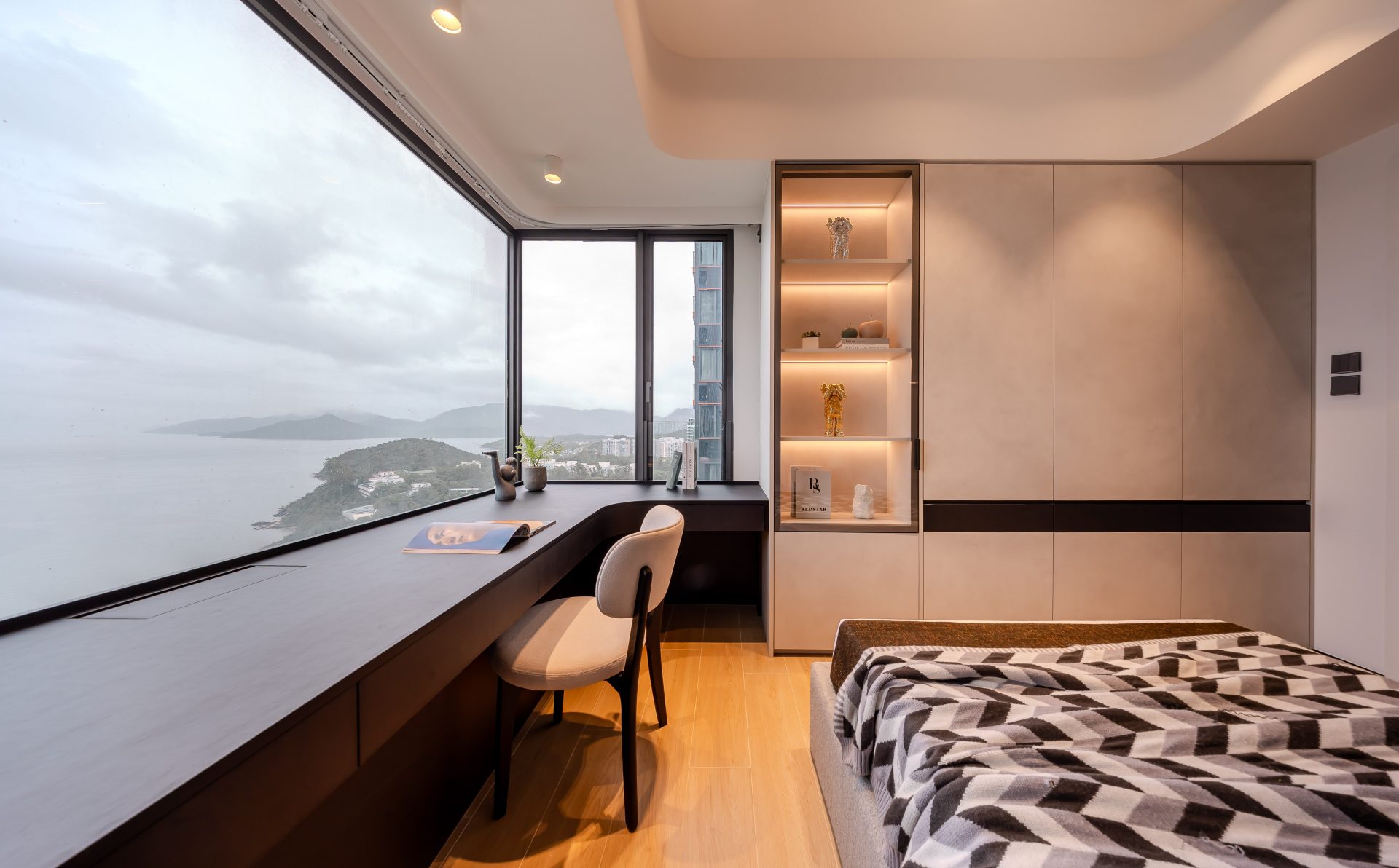 Double Cove — bedroom combining a window-side desk with illuminated display shelving