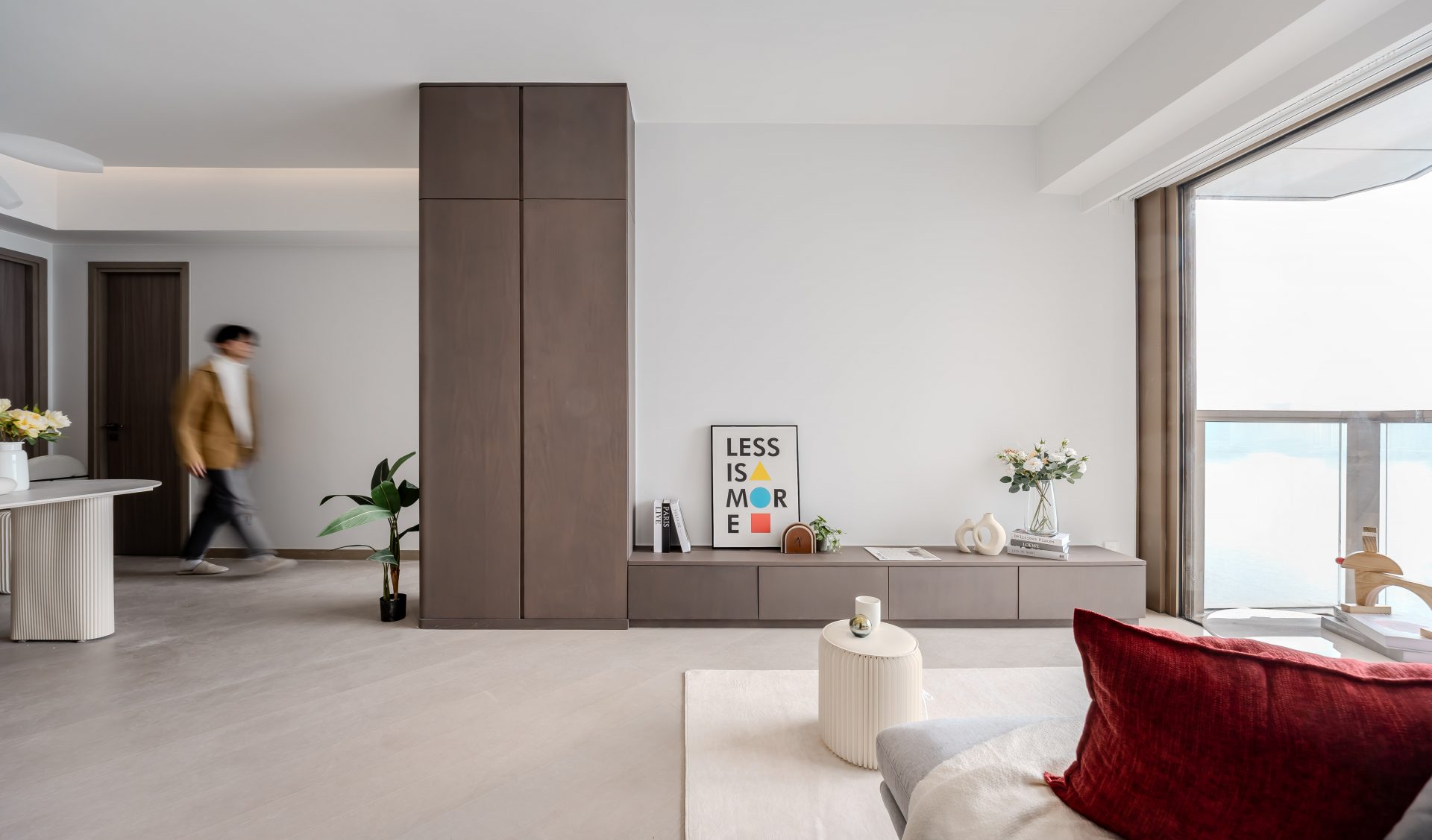 Pano Harbour — The living room is defined by dark wood-grain tall cabinets that extend into a low TV console, maintaining an open visual flow.